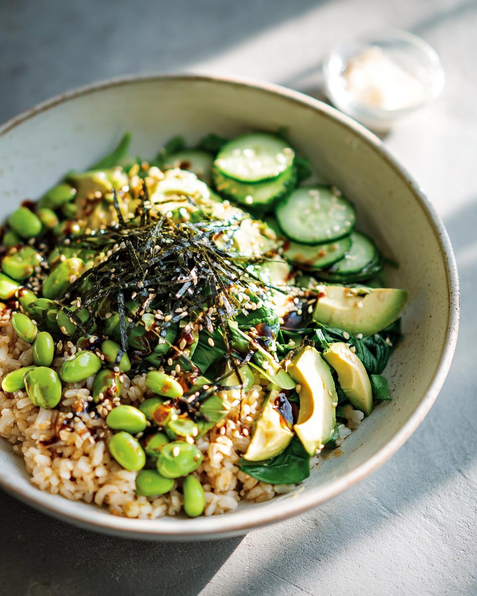 A vibrant and healthy rice bowl recipe for beginners, featuring brown rice, edamame, avocado, cucumber, and seaweed.