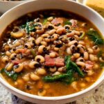 A close-up of a bowl of hearty black eyed pea soup with ham and spinach, part of The Ultimate Soup Recipes Guide.