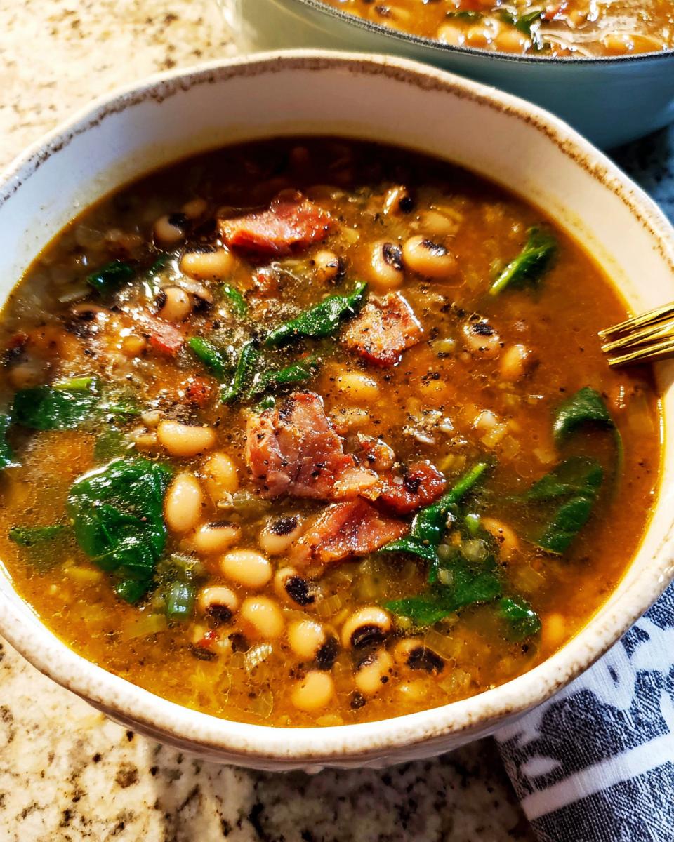 A close-up of a bowl of black eyed peas soup with bacon and spinach, part of The Ultimate Soup Recipes Guide for Beginners.