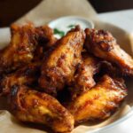 A close-up shot of a bowl filled with crispy, golden-brown chicken wings, perfect for quick chicken wings recipes.