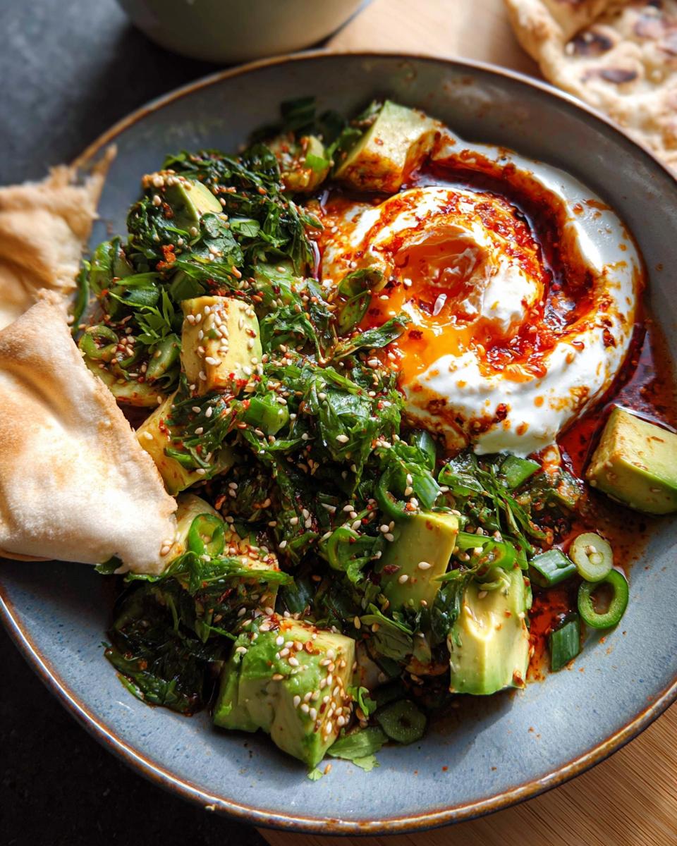 A vibrant bowl of healthy meal with avocado, greens, yogurt, and chili oil, perfect for healthy meals recipes.