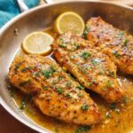 Three pan-seared chicken breasts in a lemon garlic sauce with parsley and lemon slices, perfect for 7 Genius Healthy Meals Recipes Ideas for Busy Weeknights.