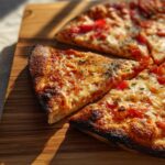 Close-up of a freshly baked pizza with melted cheese and tomato slices, perfect for Pizza Night Recipes.