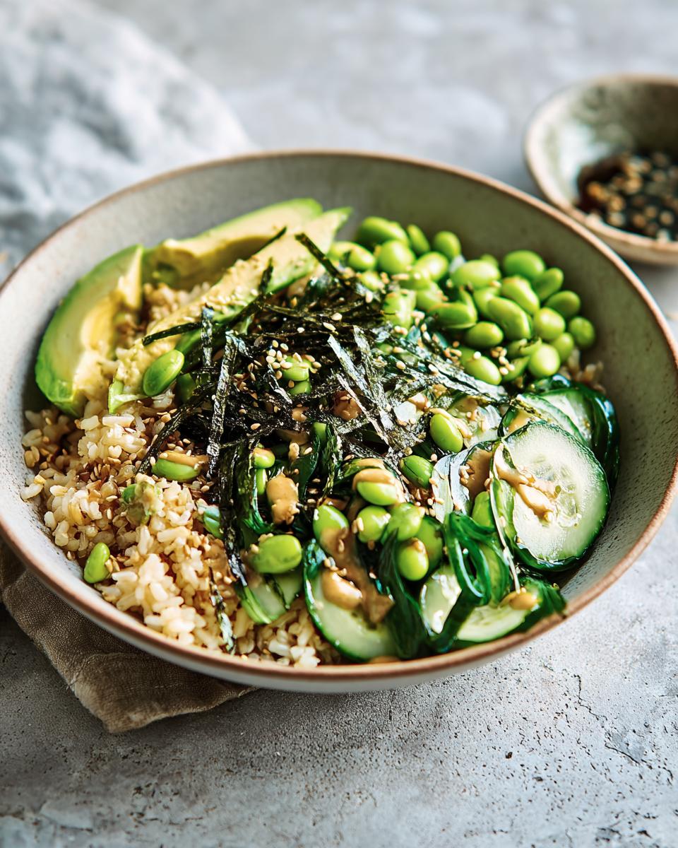 A vibrant and healthy rice bowl for beginners, featuring brown rice, edamame, avocado, cucumber, and seaweed.