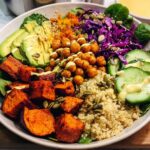 A vibrant and healthy rice bowl recipe featuring quinoa, roasted sweet potatoes, avocado, chickpeas, cucumber, and red cabbage.