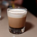 A layered Starbucks drink with foamy milk on top in a clear glass, perfect for busy weeknights.