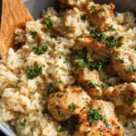 Close-up of Creamy Cajun Chicken & Rice Bowls, featuring tender chicken pieces in a rich sauce with fluffy rice, garnished with fresh parsley.