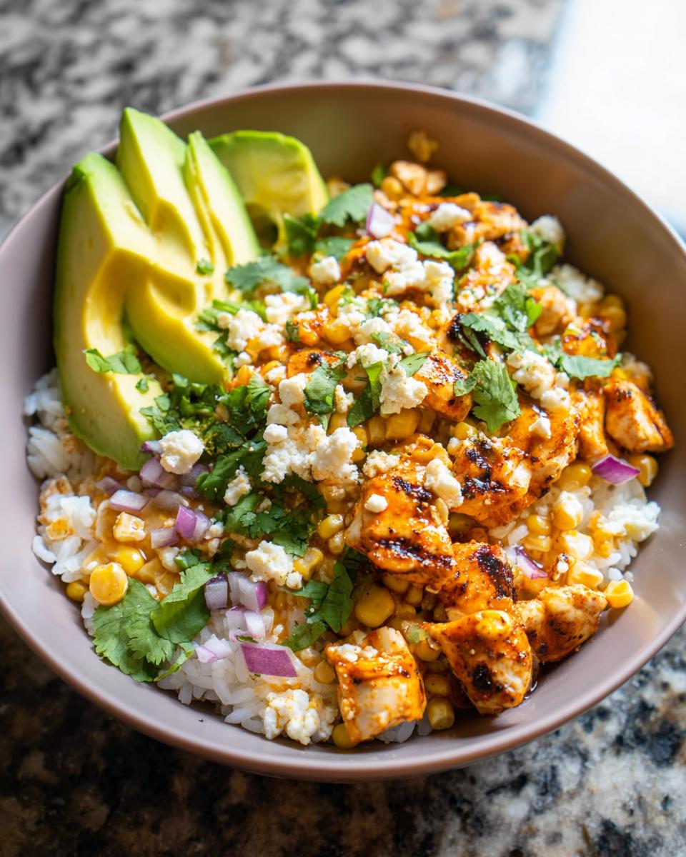 A vibrant Easy Street Corn Chicken Bowl topped with grilled chicken, corn, avocado, crumbled cheese, and cilantro.