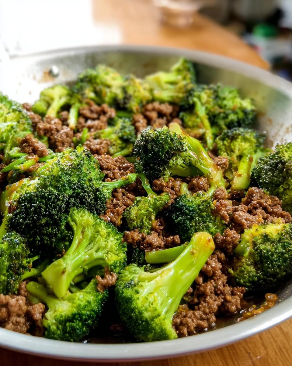 Close-up of a Keto Hamburger Broccoli Skillet, showing tender broccoli florets mixed with seasoned ground beef in a pan.