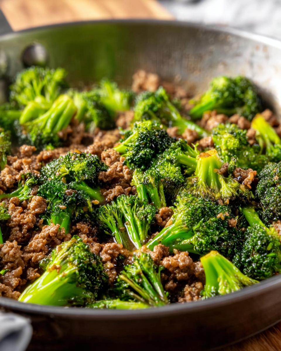 Close-up of a Keto Hamburger Broccoli Skillet with browned ground beef and vibrant green broccoli florets in a pan.