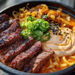 Close-up of a bowl of Spicy Korean Ramen with Grilled Beef & Creamy Sauce, featuring sliced grilled beef, ramen noodles, and a swirl of creamy sauce.