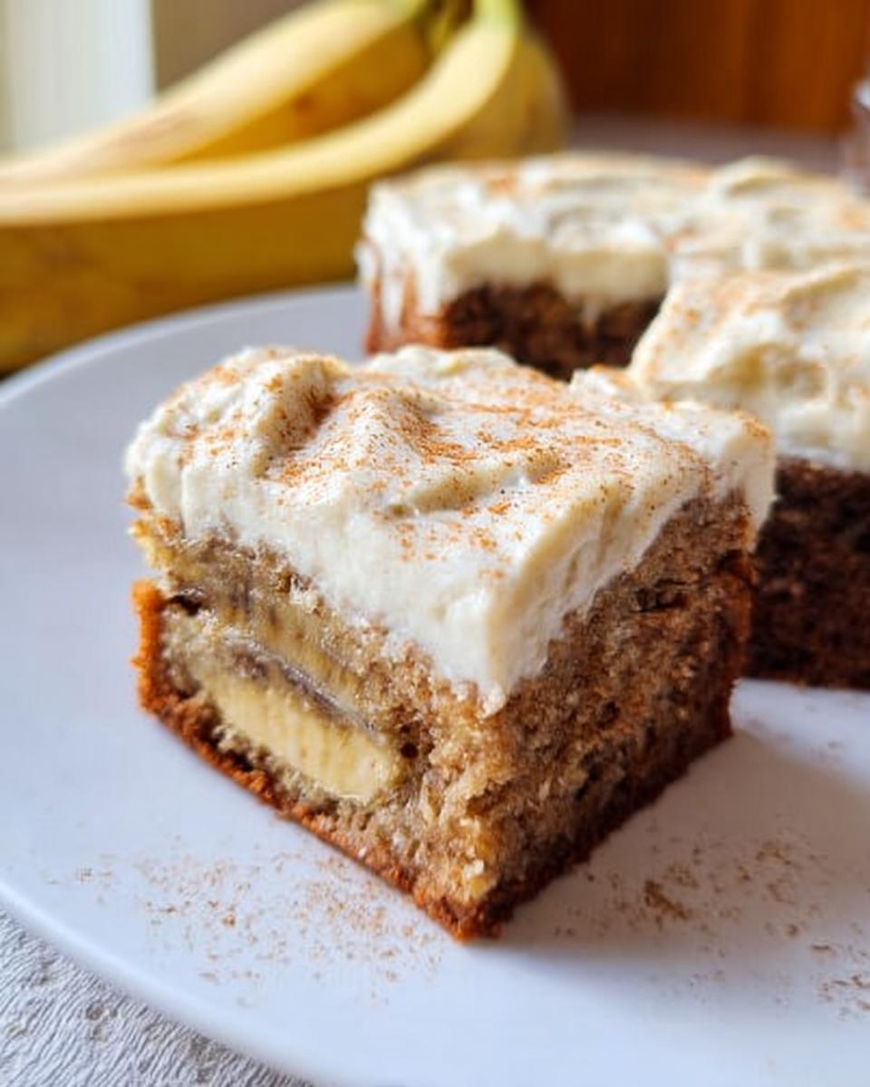 A slice of Banana Bread Brownies Made Easy, topped with creamy frosting and a sprinkle of cinnamon.