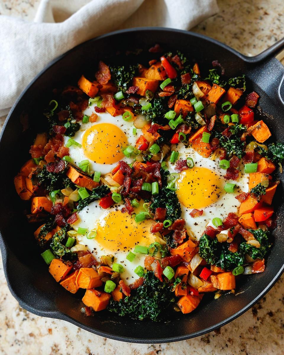 A cast iron skillet filled with a colorful BREAKFAST SWEET POTATO hash, topped with fried eggs, bacon, and green onions.
