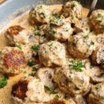 Close-up of delicious Creamy Mushroom Chicken Meatballs simmering in a rich, savory sauce with sliced mushrooms and parsley.