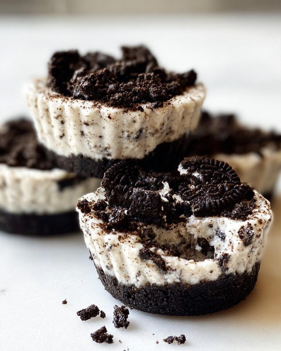 A close-up of stacked Healthy No-Bake Oreo Cheesecake Bites, topped with crushed Oreos.