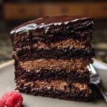 A decadent slice of Dark Chocolate Mousse Cake with rich chocolate layers and creamy mousse filling.