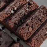 Close-up of sliced Greek Yogurt Brownies, showing rich chocolate texture and embedded chocolate chips.