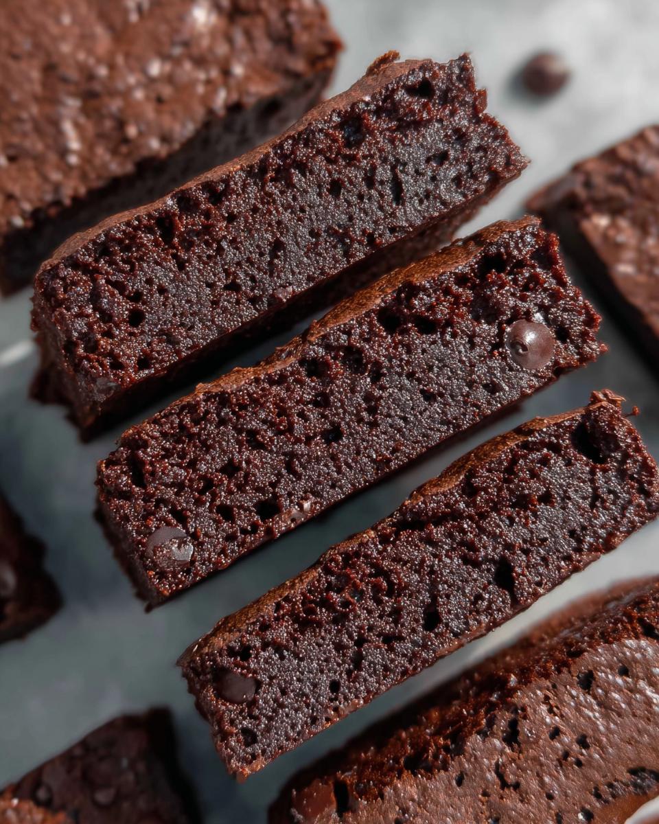 Close-up of moist Greek Yogurt Brownies slices with visible chocolate chips.