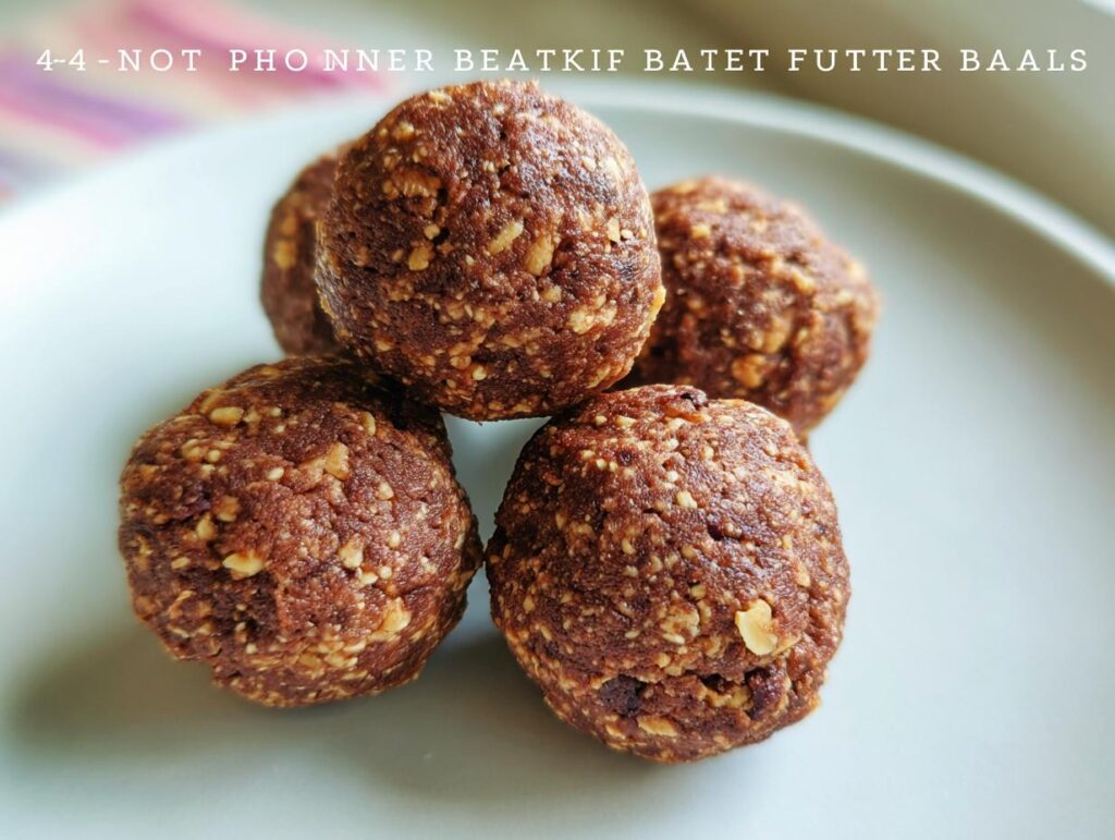 A close-up of four No-Bake Chocolate Peanut Butter Protein Balls stacked on a light gray plate.