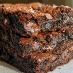 Close-up of a stack of fudgy, rich, tasty zero sugar brownies with melted chocolate chips.